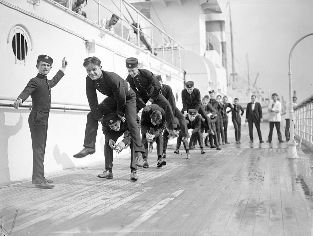 Bellhops playing leapfrog on the sun deck of the US liner Leviathan, 1923