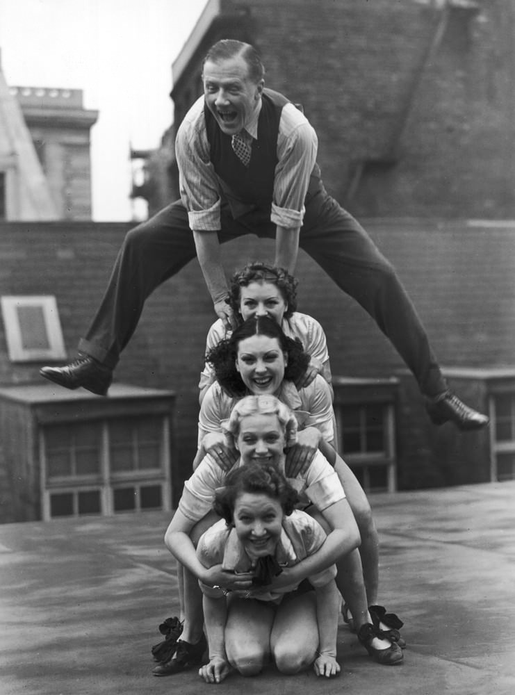 Jack Payne and the Manhattan Six dance troupe rehearsing on the roof of the Holborn Empire, 1938