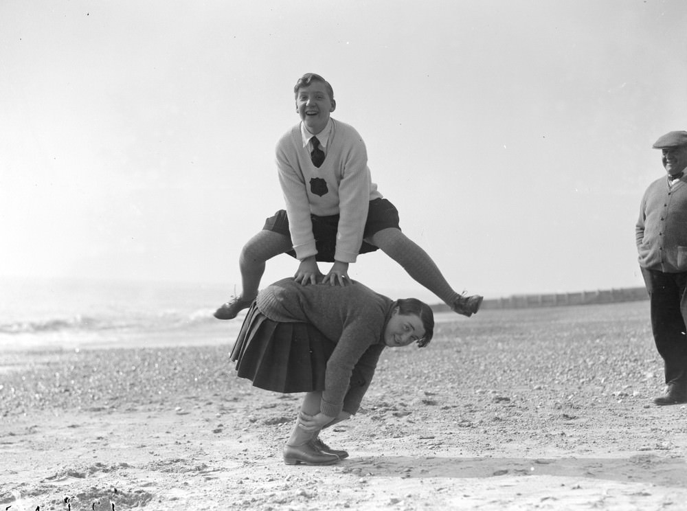 Young women playing leapfrog on the beach at Hove, 1929