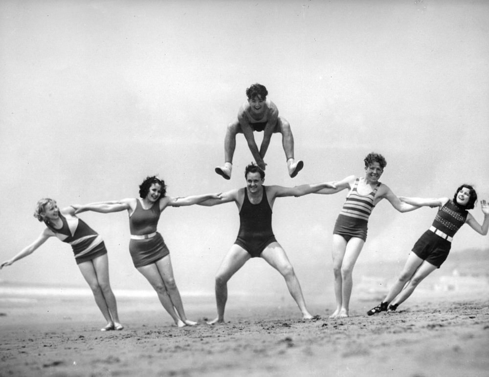 People playing leapfrog on a Californian beach, 1930