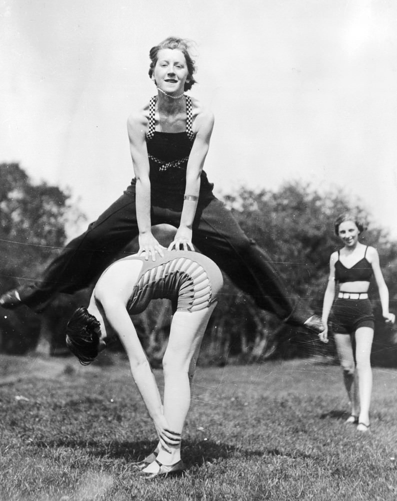Women camping near the River Thames playing leapfrog, 1935