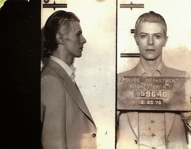 Music legend David Bowie was arrested in upstate New York in March 1976 on a felony pot possession charge. The Thin White Duke, 29 at the time, was nabbed along with Iggy Pop and two other codefendants at a Rochester hotel following a concert. Bowie was held in the Monroe County jail for a few hours before being released. The above Rochester Police Department mug shot was taken three days after Bowie's arrest, when the performer appeared at City Court for arraignment.