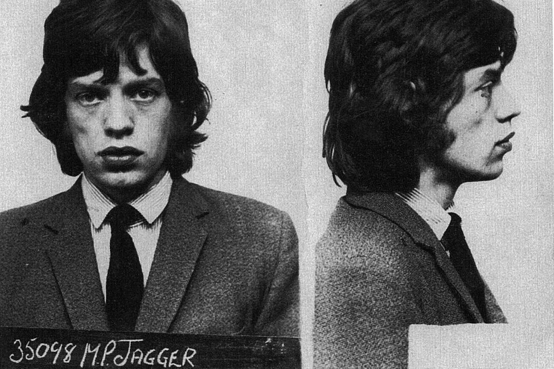 Mick Jagger posed for the above mug shot in 1967 after being arrested in England on a narcotics charge. Jagger, 23, was busted after police, acting on a tip, raided the country home of fellow Rolling Stone Keith Richards, who was also collared. Jagger, photographed at a Brixton jail, spent a few nights in custody before making bail.