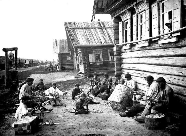 Men and boys making baskets outside their homes, 1900s