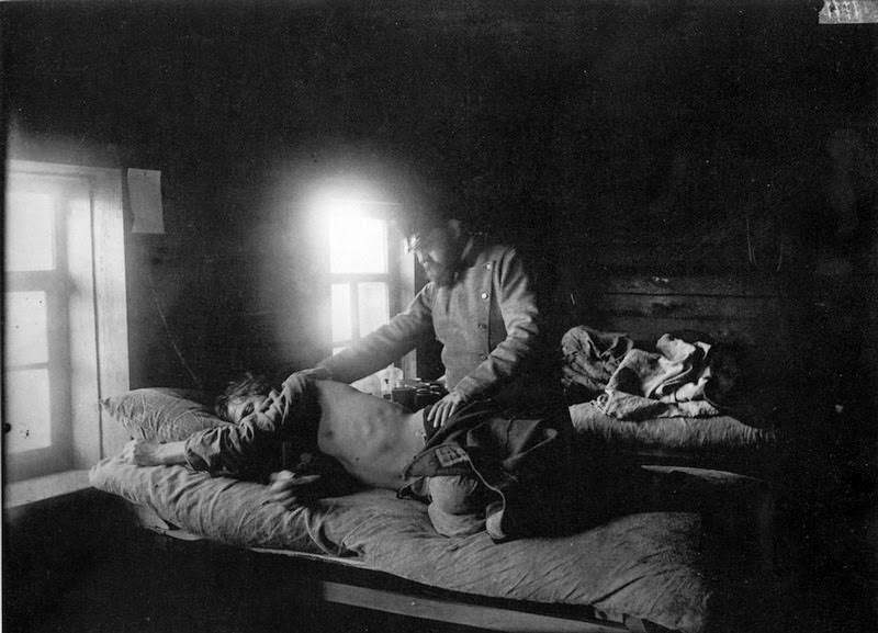 Doctor with a patient in a village house, 1900s
