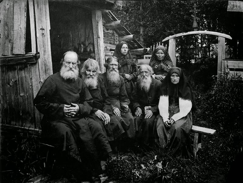 Priests and women sitting together, 1900s