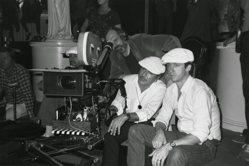 De Palma checks out a shot, with cinematographer John A. Alonzo and Al Pacino standing by.