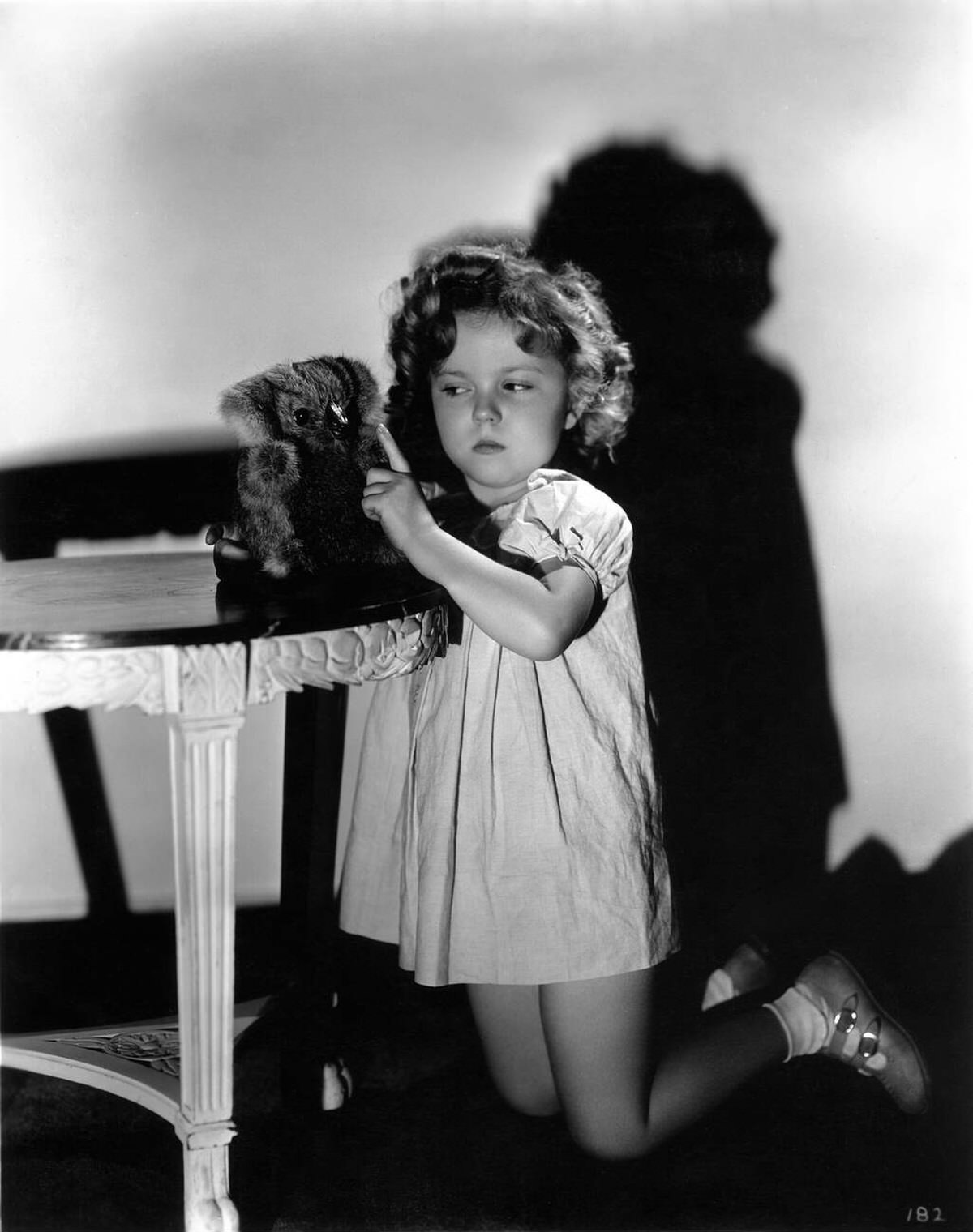 Shirley Temple with a koala bear soft toy, 1934