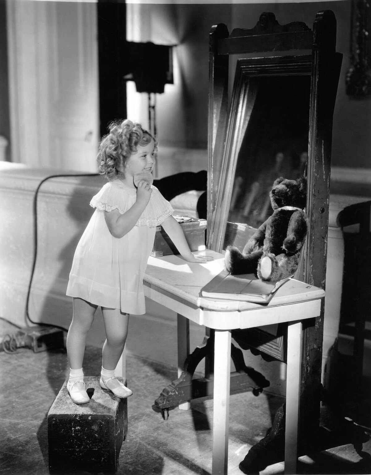 Shirley Temple at her dressing table on set, Now and Forever, 1934