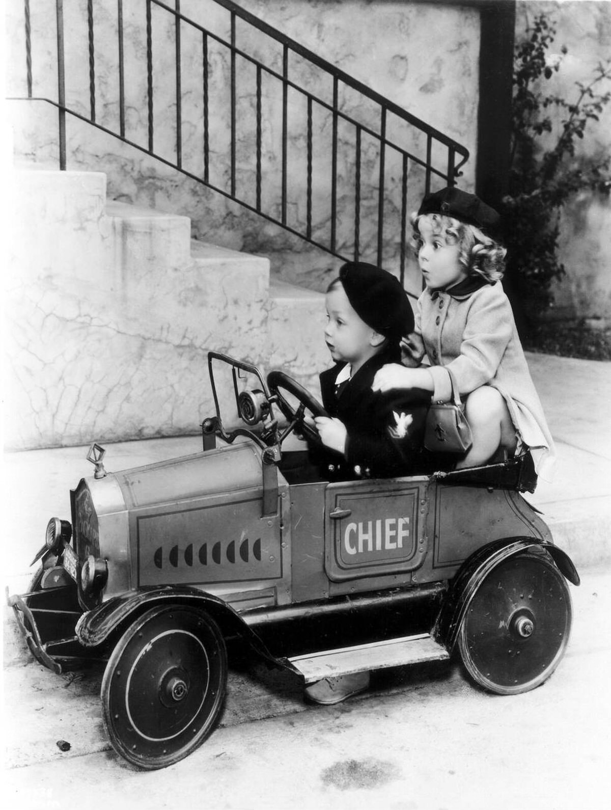 Shirley Temple with a toy car, 1934