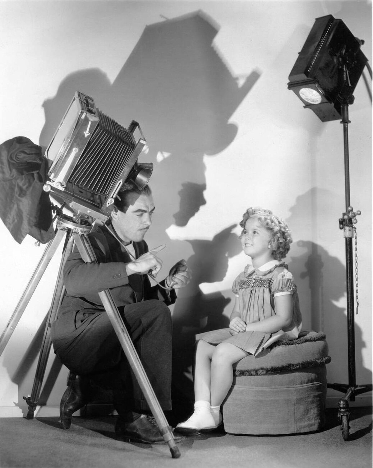 Shirley Temple with photographer Frank Powolny, 1935