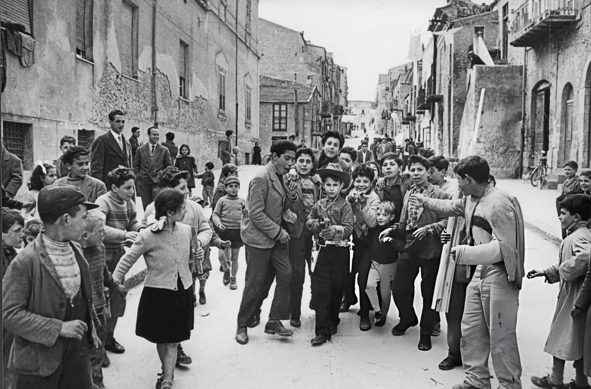 Giuseppe Miceli posing with a group of children and teenagers in Canicattì, 1958