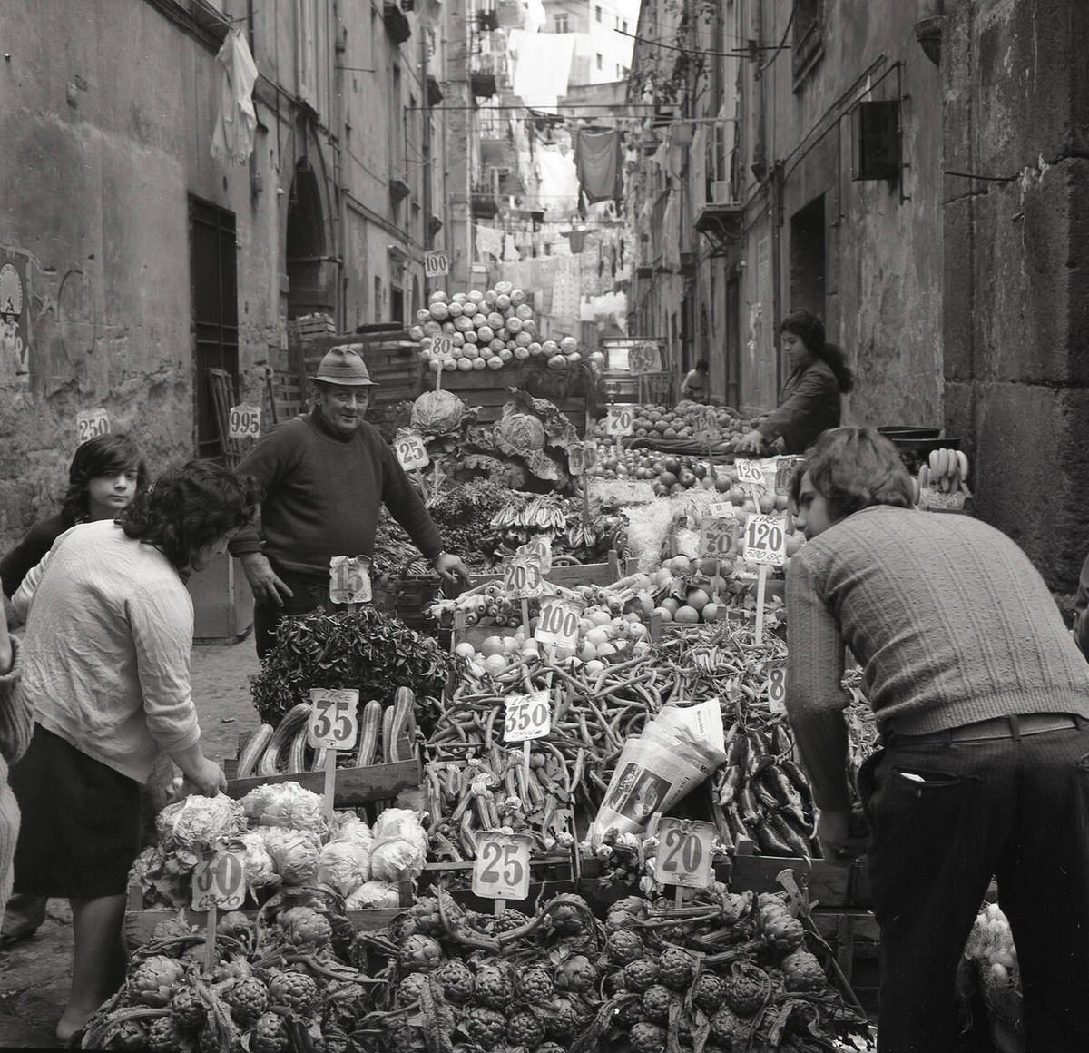 Owner and staff of a street market stall in Sicily, 1950s
