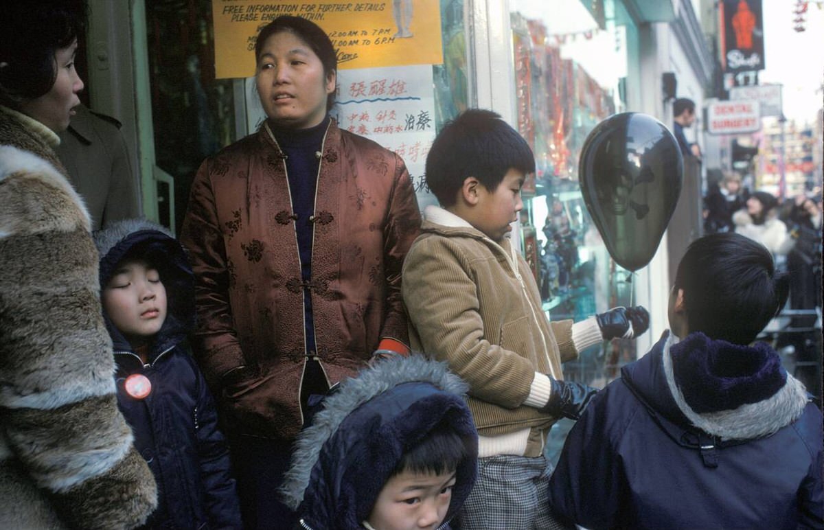 Chinese mothers and children in Gerrard Street during Chinese New Year, 1975