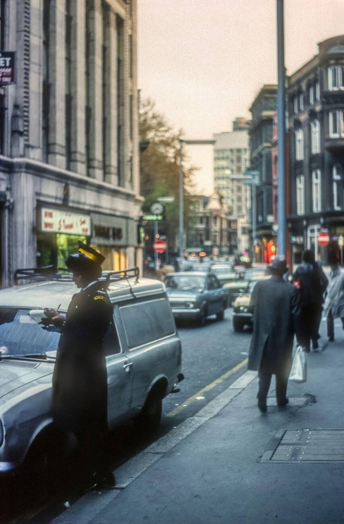 Traffic warden writing a ticket in Wardour Street, 1976