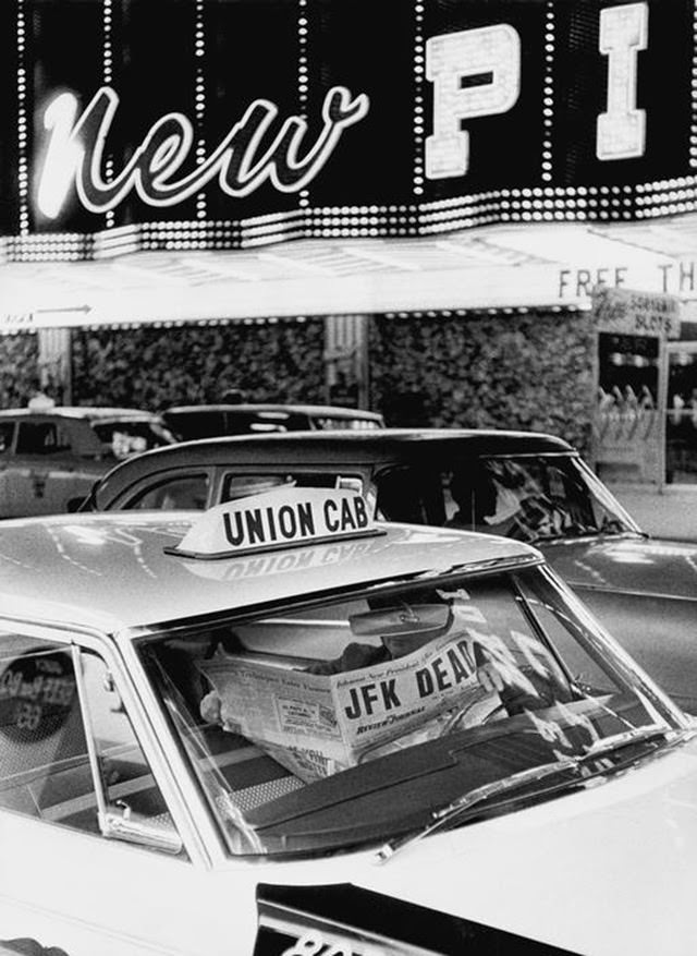 Taxi driver with a newspaper announcing the assassination of John F. Kennedy in Las Vegas, 1963