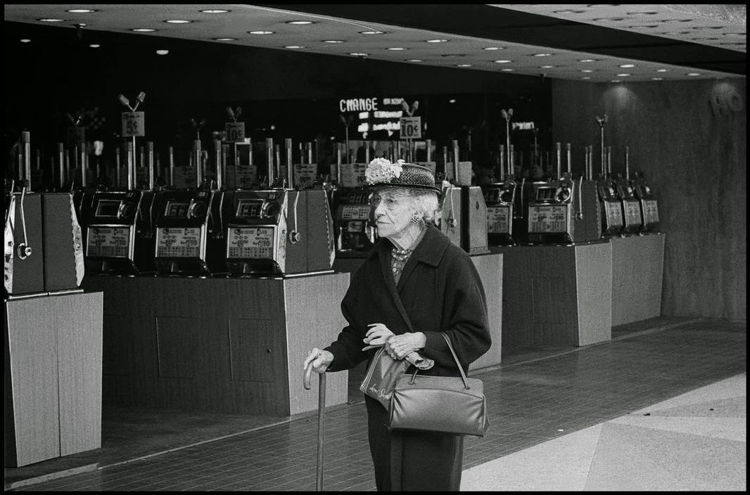 Woman walking past a casino with slot machines in Reno, 1963