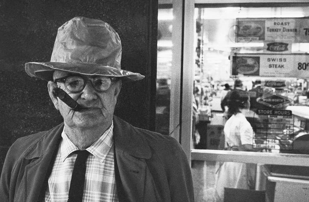 Man with a cigar on a downtown street at night in San Francisco, 1963