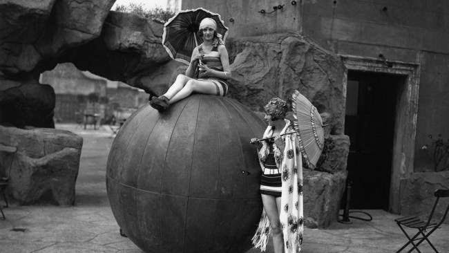 Two women modeling beachwear beside a giant beach ball on a London rooftop, 1928