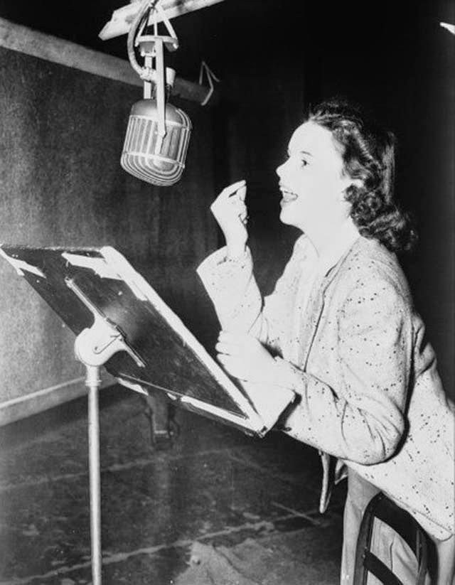 Judy Garland recording a vocal track on the MGM orchestra stage, The Wizard of Oz, 1939