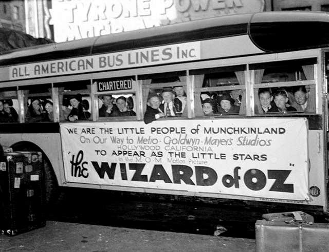 Actors playing Munchkins aboard a bus headed to the studio, The Wizard of Oz, 1939