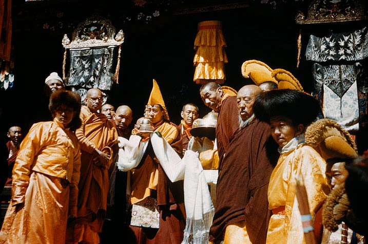 In sublime reverence, the Dalai Lama cradles his faith's holiest relic. When this young man was two years old, mysterious signs revealed him as the incarnation of Tibet's patron god, Chanrezi, and the previous 13 Dalai Lamas. Here at Dungkhar Monastery he receives a gold-encased bone which Tibetans believe to be that of Gautama Buddha, who founded the religion on which Lamaism is based.