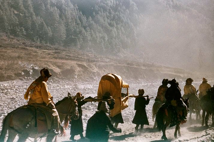 Clouds of dust and incense veil the Dalai Lama's flight to safety. When China's troops entered Tibet in 1950, the Living Buddha fled to the Sikkim border. Here in a sedan chair, he rides between rows of stones designed to ward off demons.