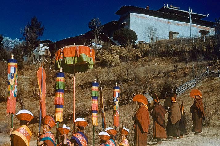 Monks and nuns since birth, Red Hat children await their god. The Dalai Lama fled Lhasa in secret, but the news swept before him. At Jang Monastery, a day's journey from the holy city, thousands of weeping monks threw themselves into the road before their ruler, begging him not to leave. Here youngsters wave banners, while their elders pray to the sound of drum and cymbal. Unlike the celibate Yellow Hat order, monks of the Red Hat sect may marry; children follow their parents into religious seclusion.