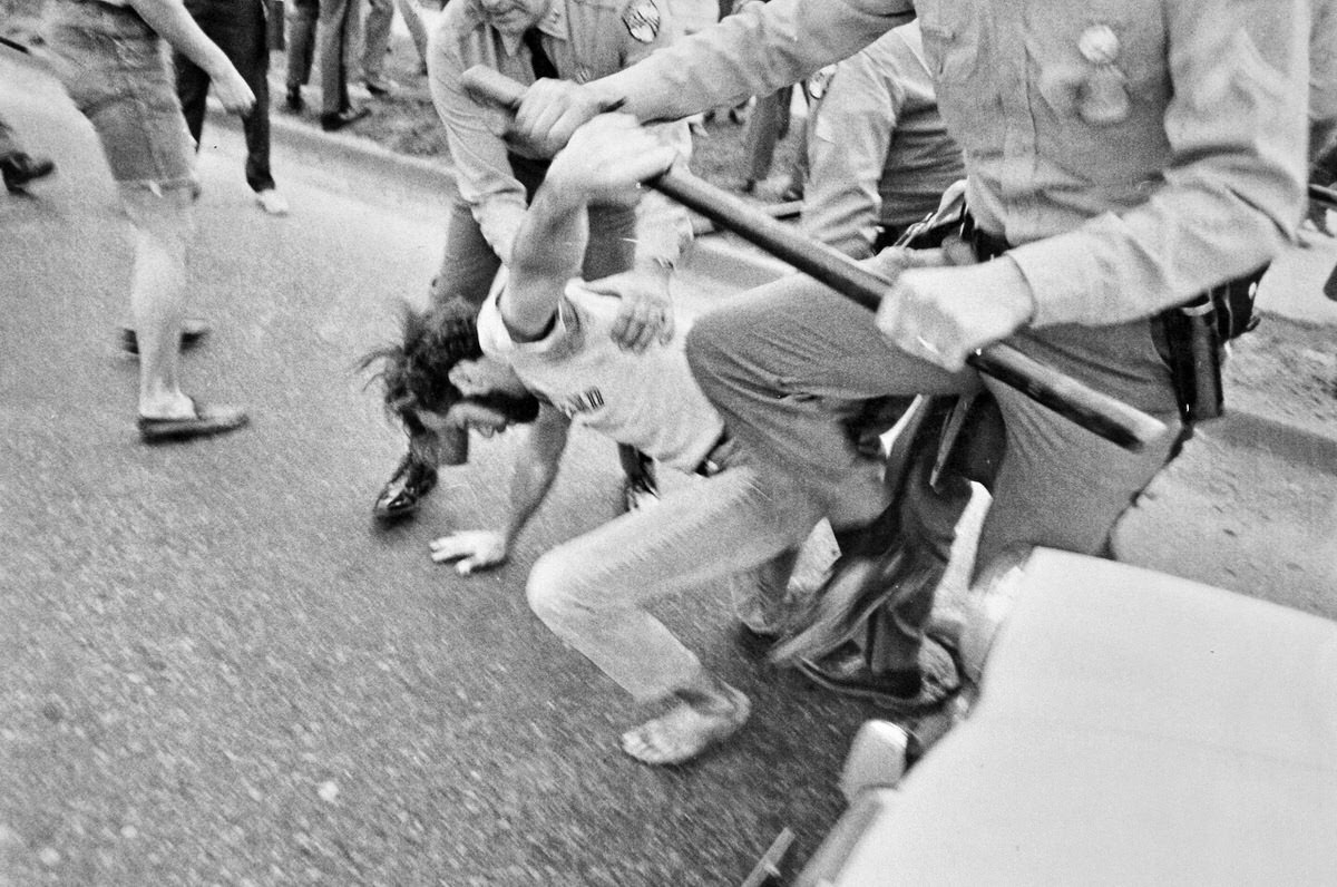 A student grabs police billy club while another officer wrestles him to the ground during an arrest on U.S. Route 1 in College Park, Md. in May 1970.
