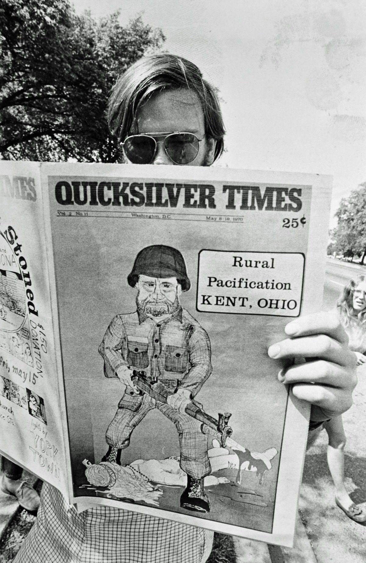 The local alternative newspaper Quicksilver Times mocks Nixon’s “pacification” of Vietnam by showing him as a National Guardsman killing students at Kent State University in their May 1970 issue.