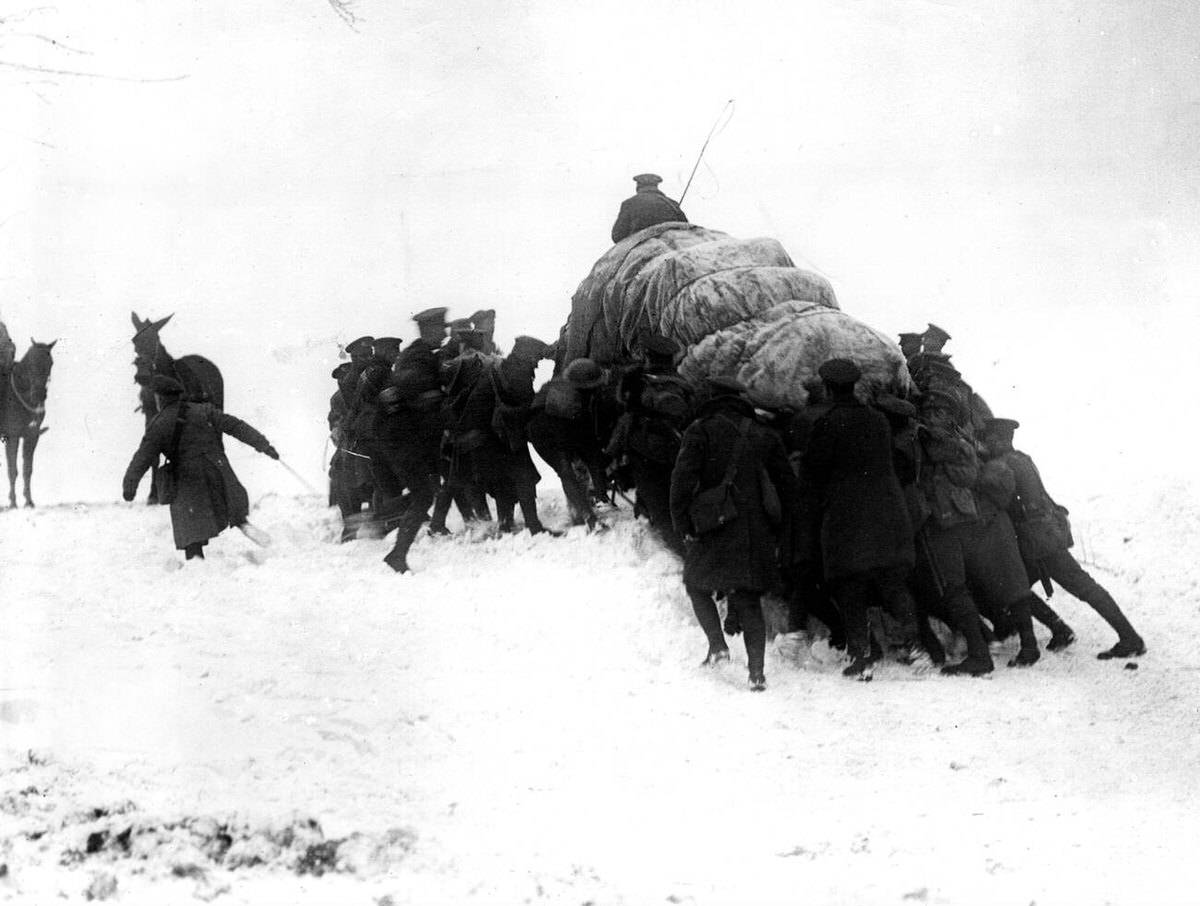 British troops pushing a horse wagon up a snowy hill near Hesdin, France, 1917
