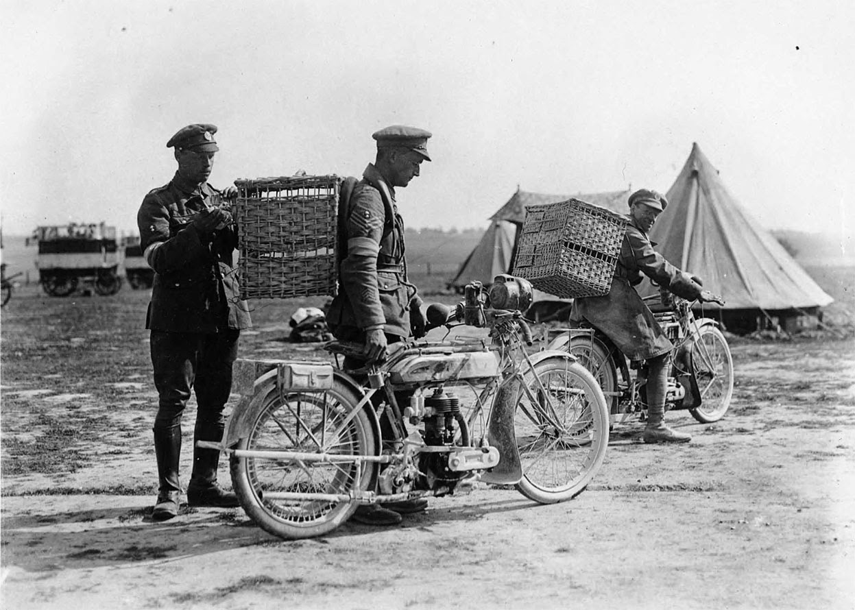 Soldiers with motorbikes and wicker baskets for transporting pigeons, 1914