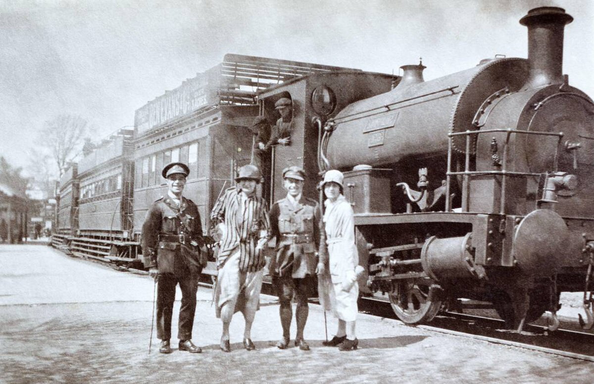 British army officers and companions next to a Mumbles Railway and Pier Company train, 1910