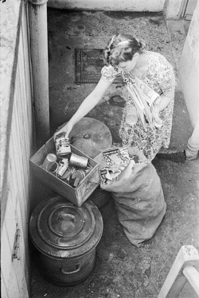 Mrs Day separates cardboard and tin from her household rubbish, ready for salvage, outside the basement of her home in South Kensington, London.