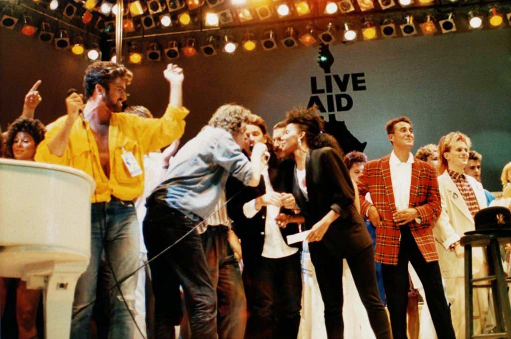 George Michael, Bob Geldof, Bono, Freddie Mercury, Andrew Ridgeley, and Howard Jones on stage at Wembley Stadium, 1985