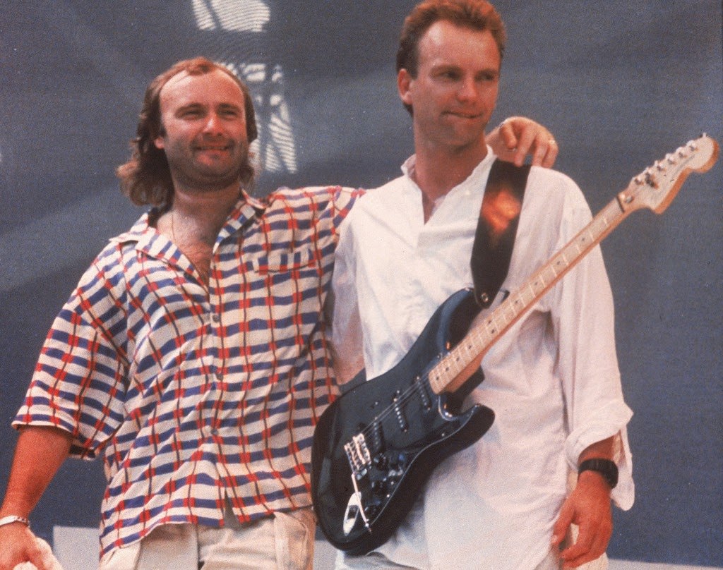 Phil Collins and Sting on stage during the Live Aid concert at Wembley Stadium, 1985