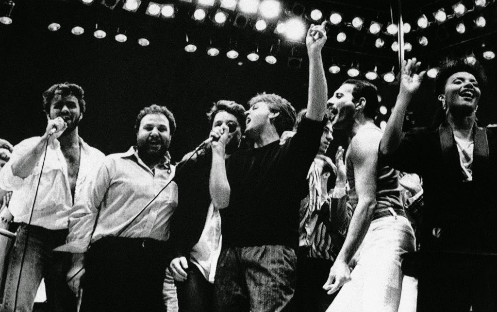 Paul McCartney, George Michael, Harvey Goldsmith, Bono, Bob Geldof, and Freddie Mercury during the Live Aid finale, 1985