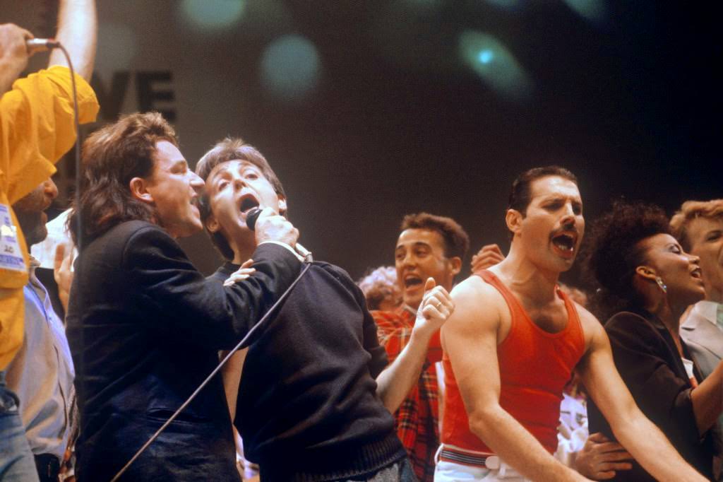 Bono, Paul McCartney, and Freddie Mercury joining other pop stars at Live Aid, 1985