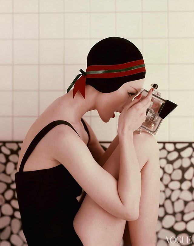 Model with a waterproof camera wearing a black bathing suit and black velvet bathing cap, 1956