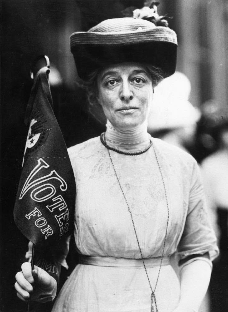 Suffragette with a Votes For Women banner, 1910