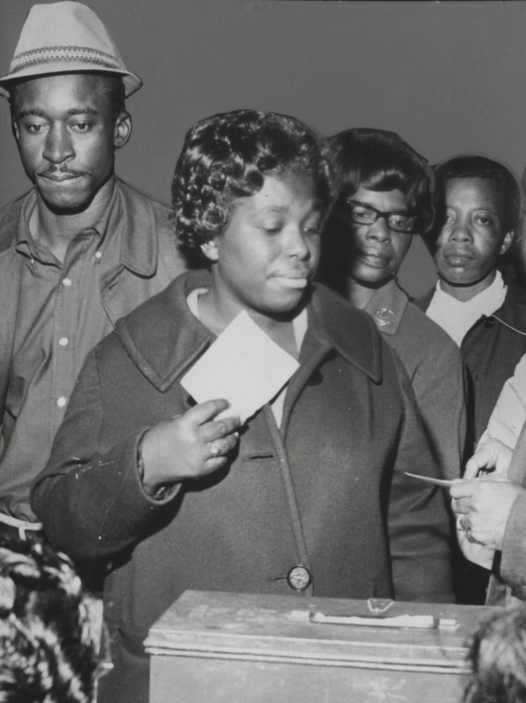 African American women at a polling station.