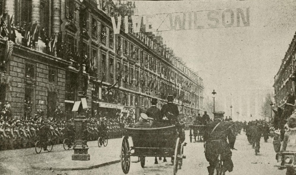 Parisians greet President Wilson on the Rue Royal.