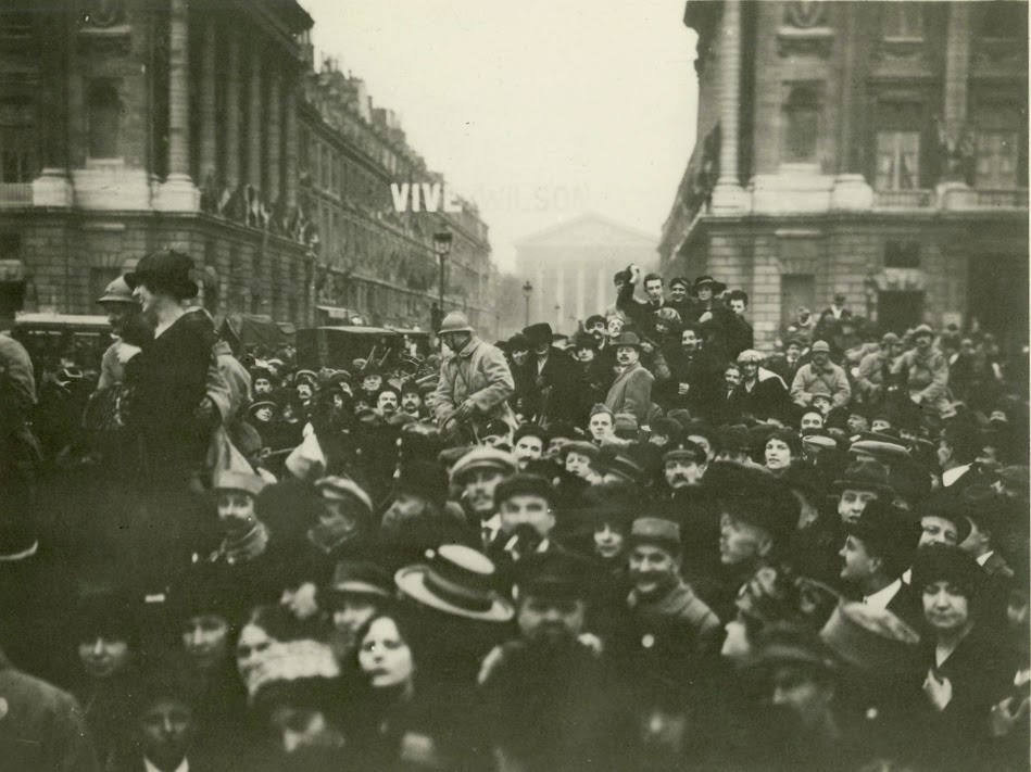 Parisians and Americans greet Woodrow Wilson in France.
