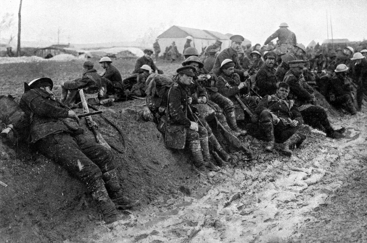 Soldiers from the Worcestershire Regiment resting in the mud on the Somme battlefield, 1916
