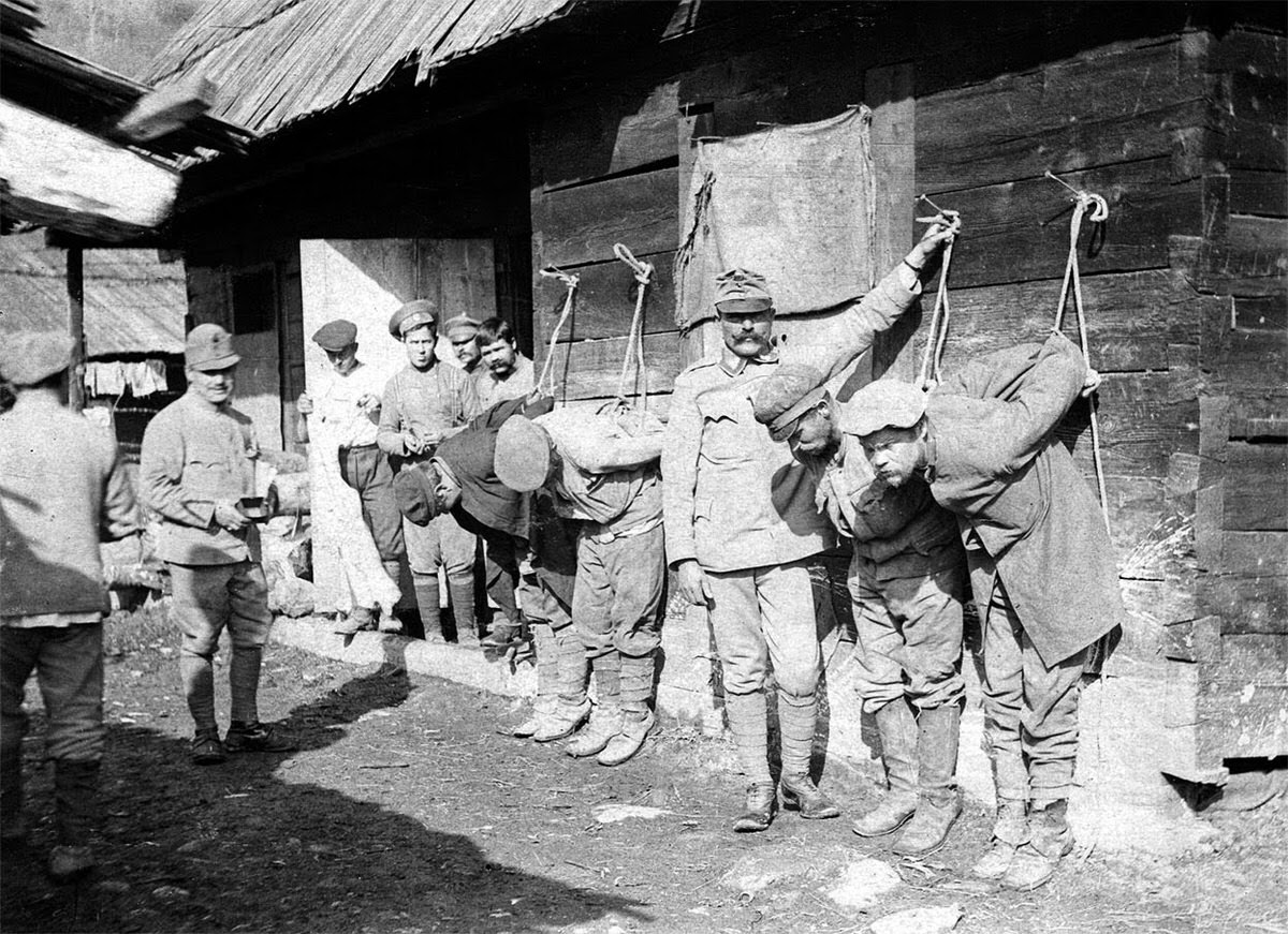 Austrian soldiers meting out punishment to Russian prisoners, 1914