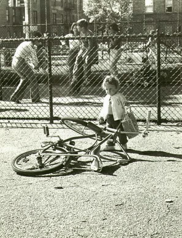 Girl looking at a bicycle in Seth Low Park, Brooklyn, 1978
