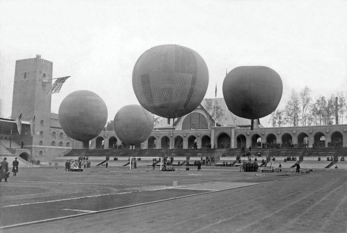 Competing teams preparing hot air balloons for takeoff at Stockholm Stadium, 1912