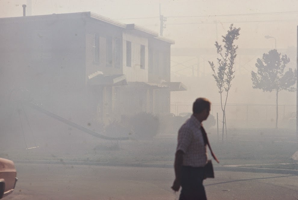 Industrial smog blacks out homes adjacent to North Birmingham pipe plant. This is the most heavily polluted area of the city, Birmingham, Alabama, 1972