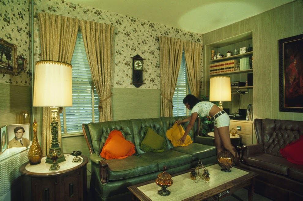 Sandra Bruno straightens a pillow in the immaculate living room of her family's home at 39 Neptune Road, Boston, Massachusetts, 1973
