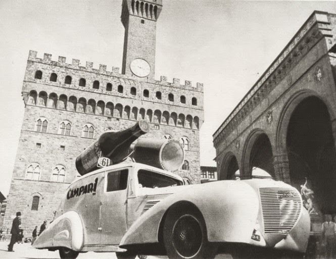 A Packard customized with bottles on the roof for Campari, in front of Palazzo Vecchio, Florence, during the Giro d'Italia, 1938